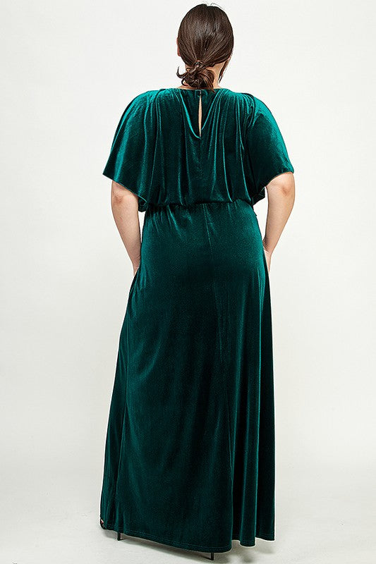 Green velvet dress worn by a person on a white background, back of the dress